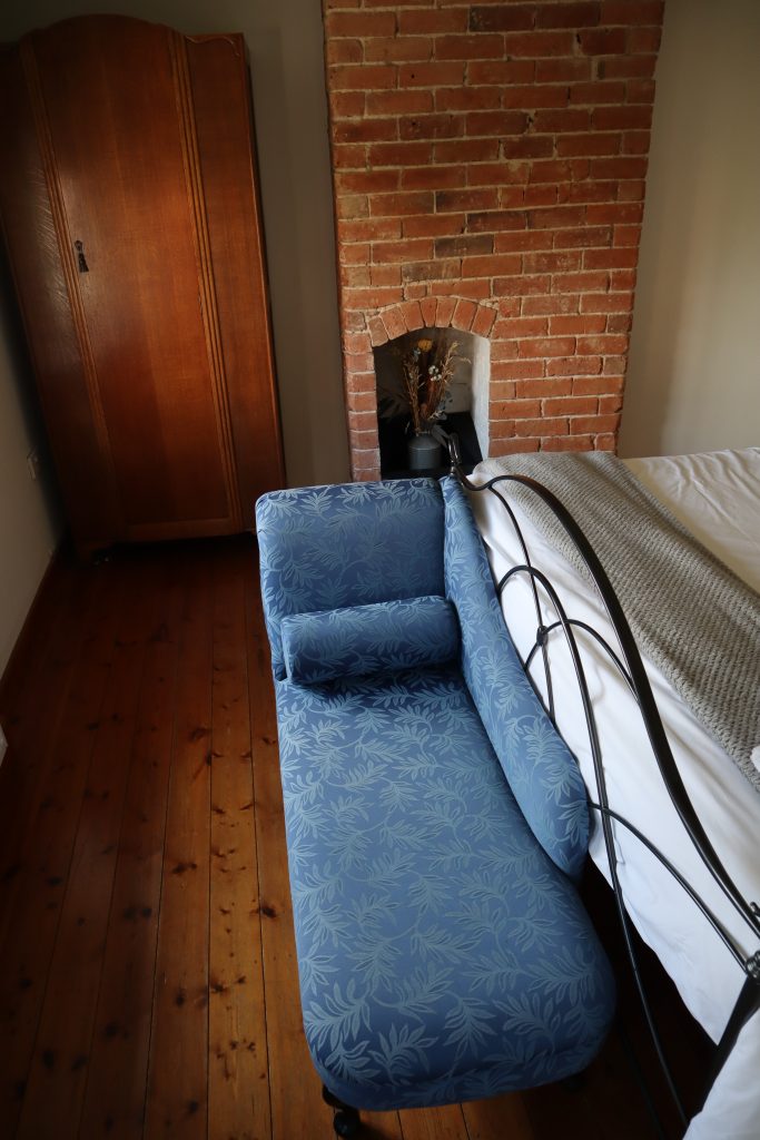 image shows chaise longue in master bedroom